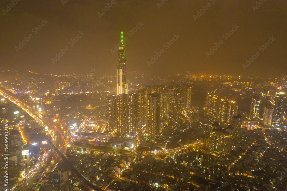 Fototapeta premium aerial view of Ho Chi Minh City in the morning, Top view aerial photo from flying drone of a Ho Chi Minh City with development buildings, transportation, energy power infrastructure.