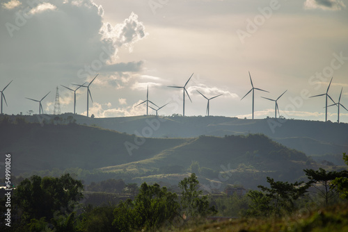 Group of windmills for renewable electric energy production. Wind turbines farm on mountains in rural areas. The clean energy system in Khao Kho District, Phetchabun, Thailand, Southeast Asia.