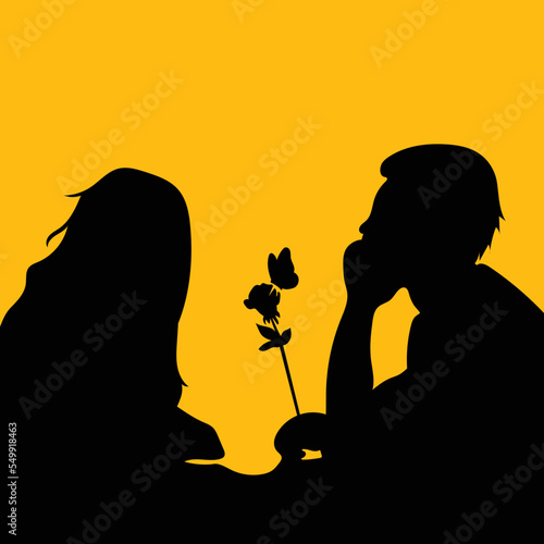Silhouette of a couple sitting together romantically