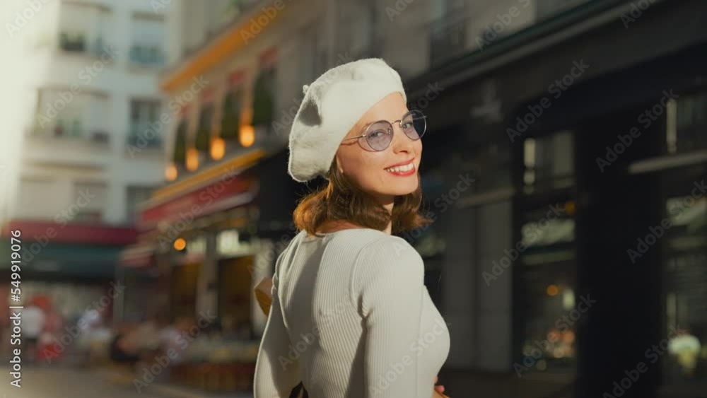 Beautiful smiling woman with baguettes outside a bakery Beautiful smiling woman with baguettes outside a bakery