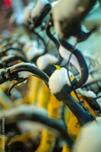 Vertical shot of city bicycles covered in snow in Shenyang, China