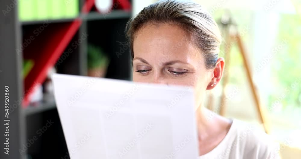 Woman carefully examines bank debt documents closeup