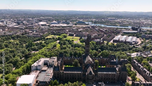 Aerial pan behind Glasgow University revealing Kelvingrove Park, Clydeside and Park Circus on a sunny day Slow photo