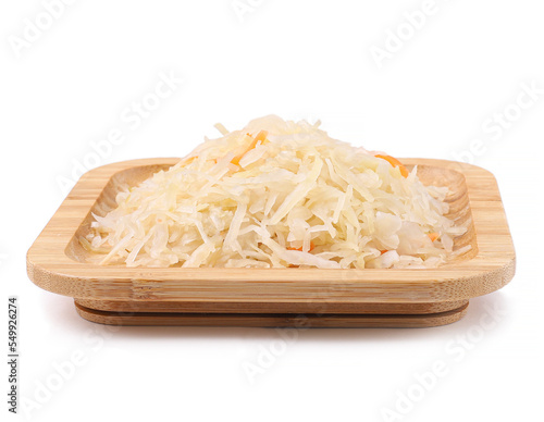 Marinated sauerkraut in wooden square plate, white background, close up