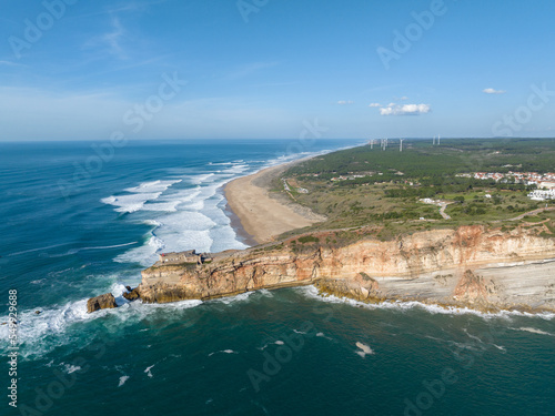 Lighthouse in Nazare, Portugal. Famous place for waves and surfing. Beach and Ocean Waves in Background