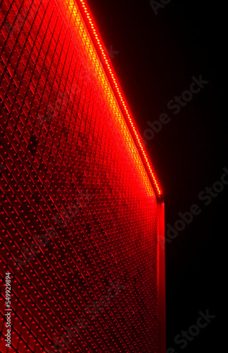 Red illuminated modern building details.