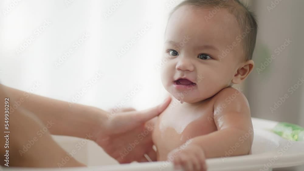Closeup view of young Asian mother is Bathing with her newborn baby In Bathtub at home.Concept of newborn,baby,parenthood,motherhood,childhood,New life,maternity,love,new family member Closeup view of young Asian mother is Bathing with her newborn baby In Bathtub at home.Concept of newborn,baby,parenthood,motherhood,childhood,New life,maternity,love,new family member