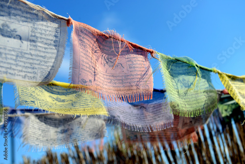 Leinwand Poster Tibetan flags moving with the wind, spreading prayers and good intentions