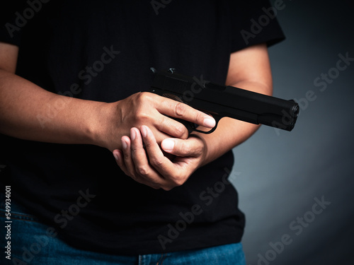 A man holding a gun is ready to shoot in self-defense