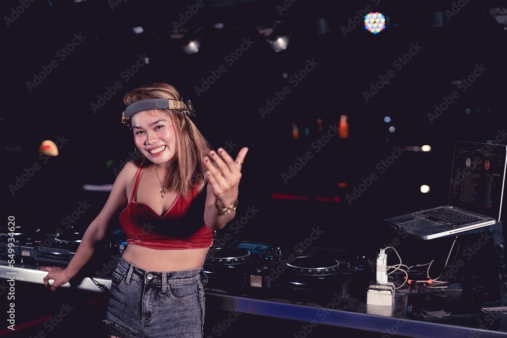 A female DJ inviting you to join the party. Nightclub or disco scene. A female DJ inviting you to join the party. Nightclub or disco scene.