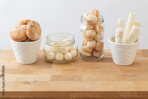Print op canvas candies and cookies  in jars on wooden shelf on white background