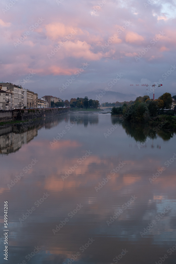 sunset over the river, red clouds reflect in the river, panorama