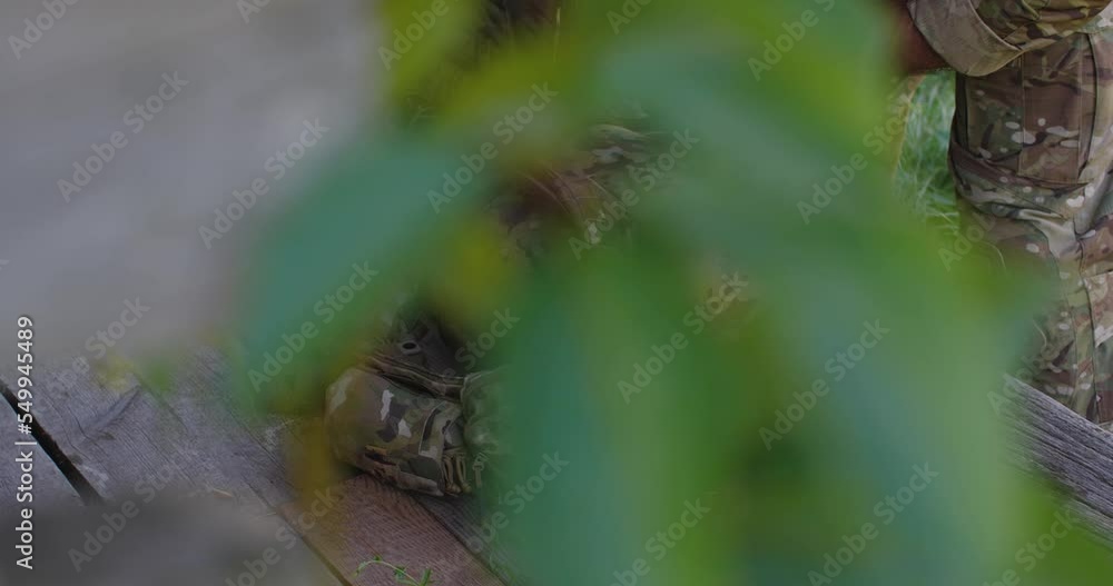 Close-up of hands of an unrecognizable male soldier in camouflage ...