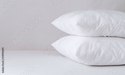 two comfortable pillows  white bed linen  no one there. Bed linen  home comfort  free space. Good morning in daylight