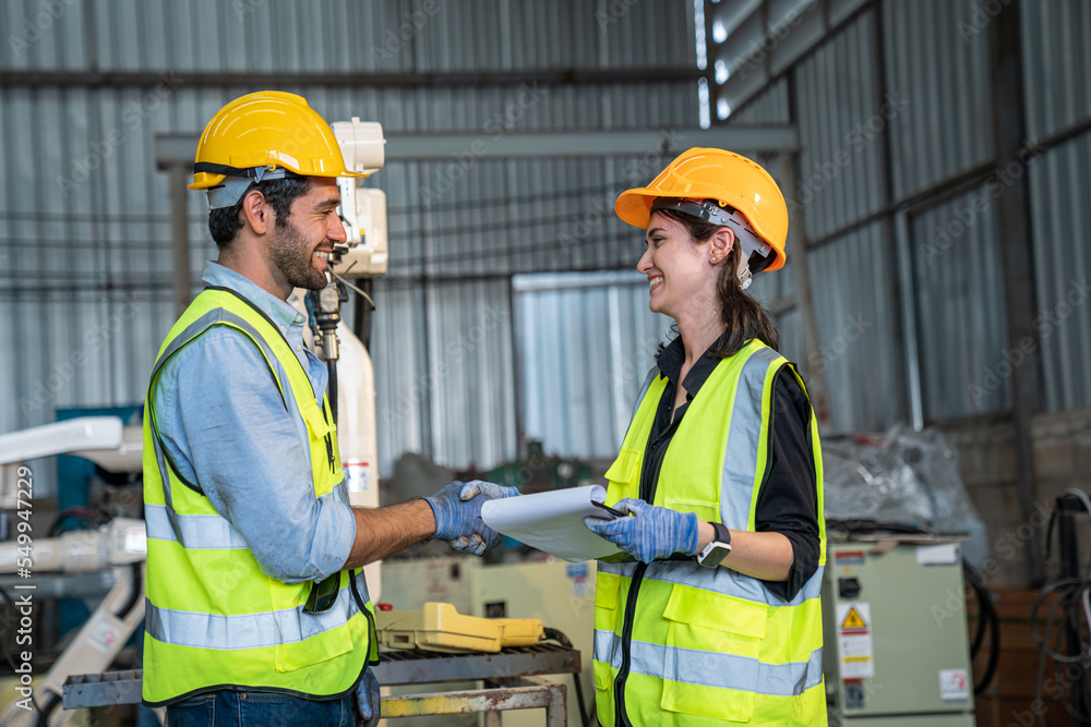 Portrait of female automation engineer team standing and working in industrial factory. Portrait of female automation engineer team standing and working in industrial factory.