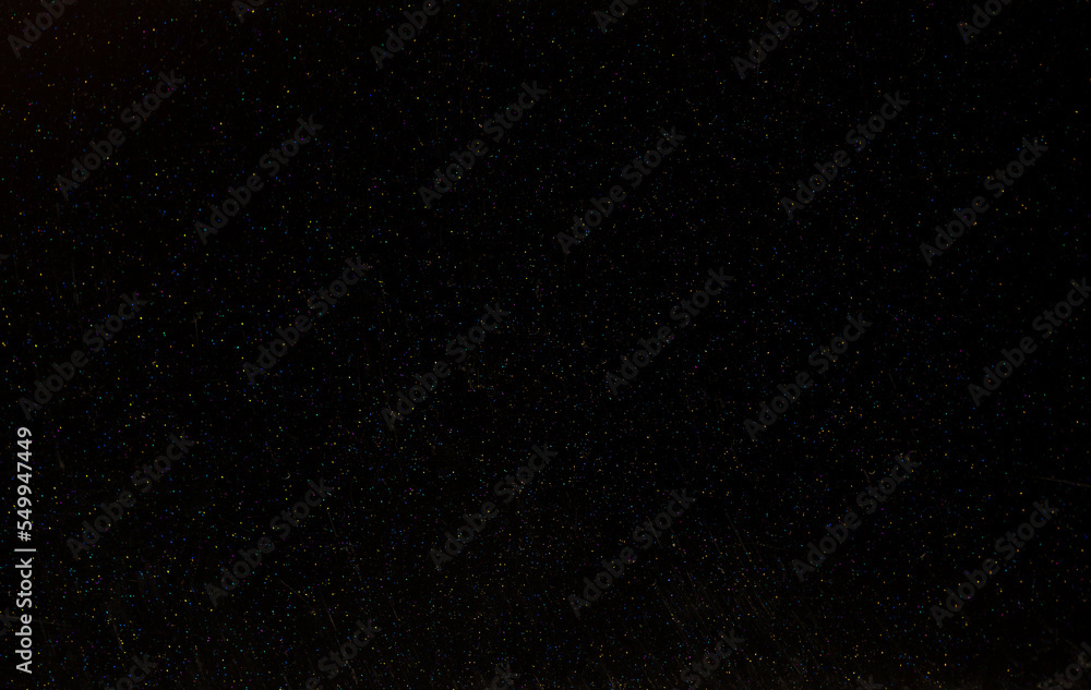 Fototapeta premium Dark background of decorative plaster with abstract spots. Unusual black or gray wall texture with beautiful patterns, creative surface background. Finishing coating for building cladding.