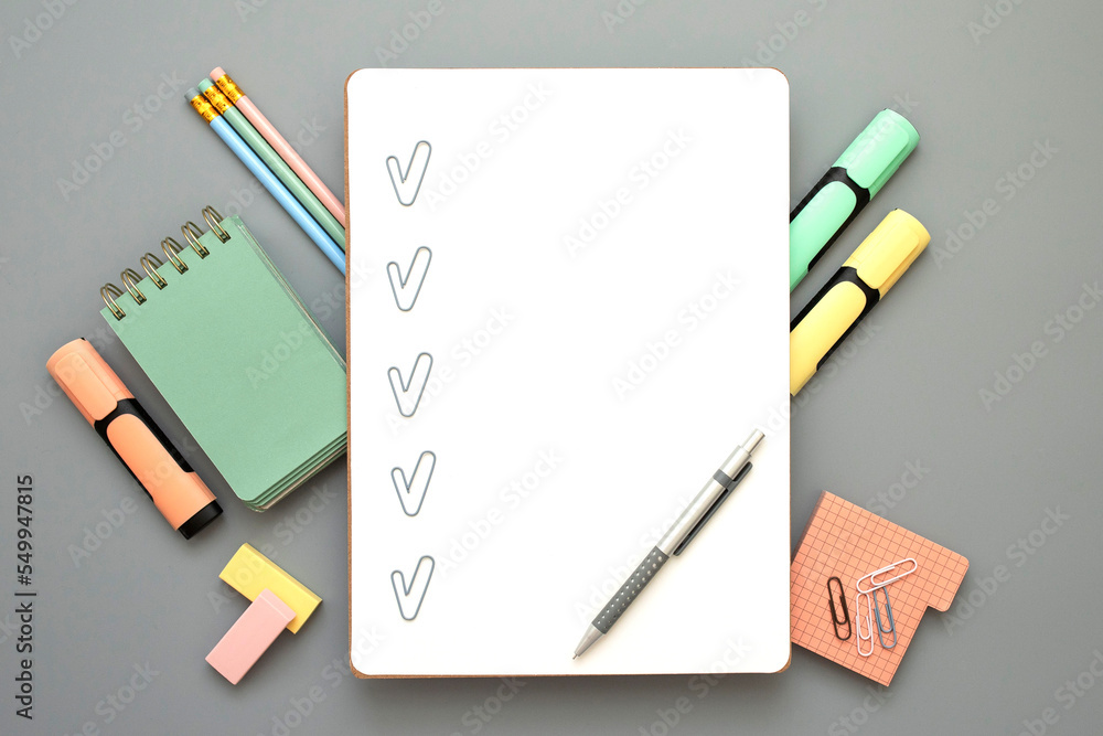 Blank checklist with paper clip checkmarks, pen on white sheet. Stylish office, educational stationery around. Checklist for office worker, student, manager, businessman. Grey background. Copy space. Blank checklist with paper clip checkmarks, pen on white sheet. Stylish office, educational stationery around. Checklist for office worker, student, manager, businessman. Grey background. Copy space.