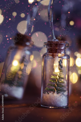 Creative Christmas garland lights with bokeh. Christmas tree in a glass jar with snow. Christmas greeting card.