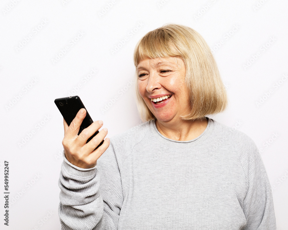 Old woman watching funny videos on internet. Old woman watching funny videos on internet.