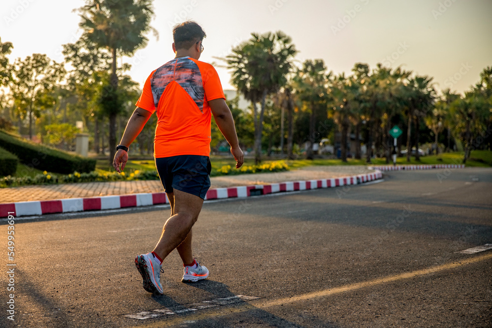 Fototapeta premium Sport man exercise walking on sunset in park for fitness healthy lifestyle.