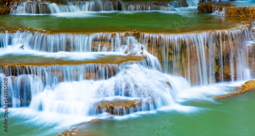 Amazing colorful waterfall in national park forest during spring beautiful deep forest in Thailand technic long exposure  during vacation and relax time.