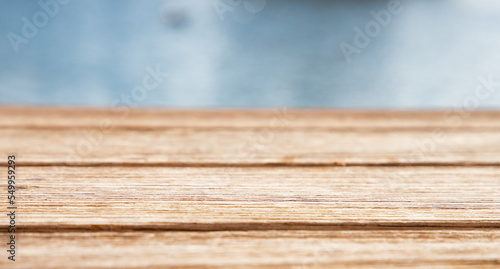 empty wooden table and sea in background