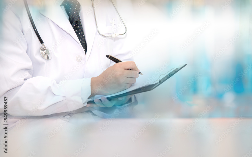 The doctor wears a ground suit, holding clipboard and writing some data, a light blue background. hospital concept, health business ,insurance and healthcare concept. The doctor wears a ground suit, holding clipboard and writing some data, a light blue background. hospital concept, health business ,insurance and healthcare concept.
