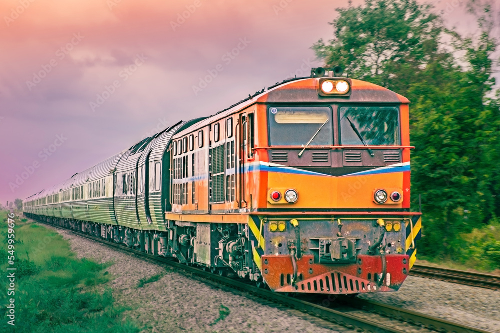 Obraz premium Passenger train by diesel locomotive on the railway.