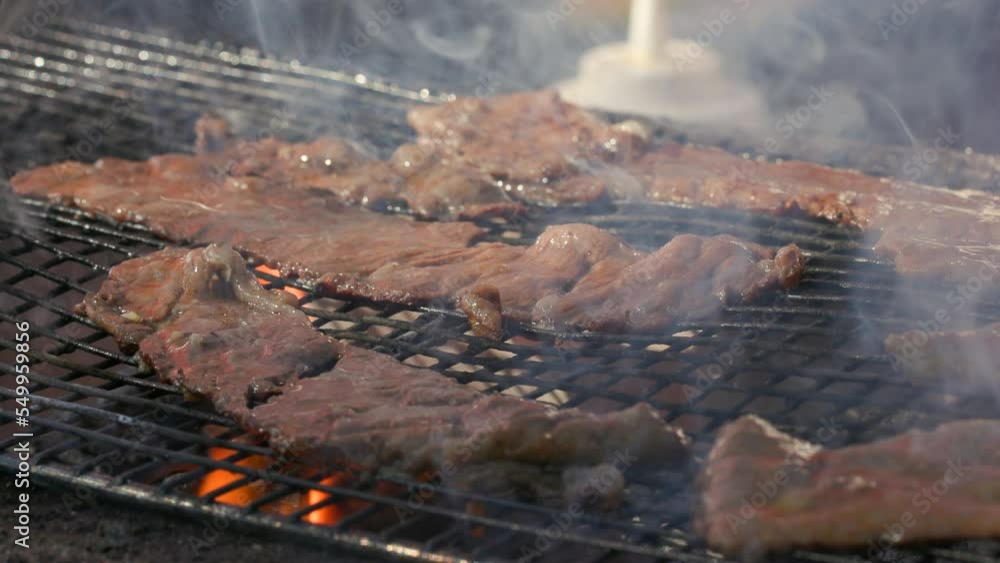 Detailed view of raw, red meat salted and peppered before grilling. Flavorous BBQ cooking on open flames outdoors. High quality 4k footage Detailed view of raw, red meat salted and peppered before grilling. Flavorous BBQ cooking on open flames outdoors. High quality 4k footage