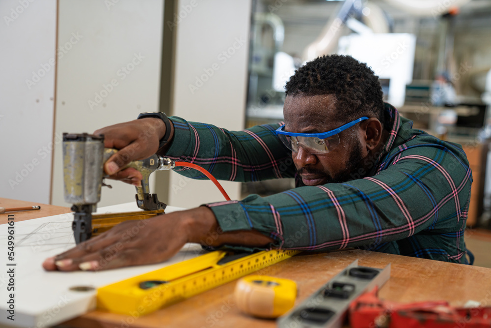 Afro american craftsman working as carpenter in a carpentry workshop, Small family business concept of young entrepreneurs. Afro american craftsman working as carpenter in a carpentry workshop, Small family business concept of young entrepreneurs.