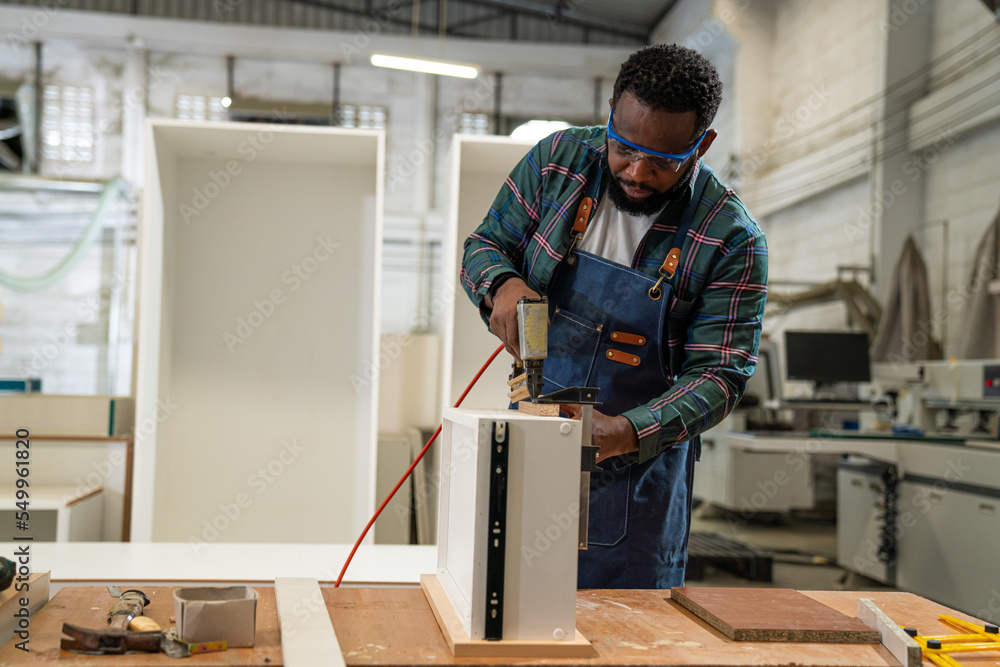 Afro american craftsman working as carpenter in a carpentry workshop, Small family business concept of young entrepreneurs. Afro american craftsman working as carpenter in a carpentry workshop, Small family business concept of young entrepreneurs.