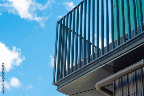 Modern metal balcony against the blue sky