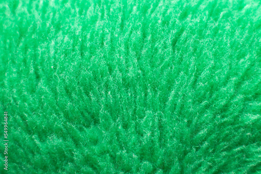Green fluffy textile texture. Nappy hairy background closeup.