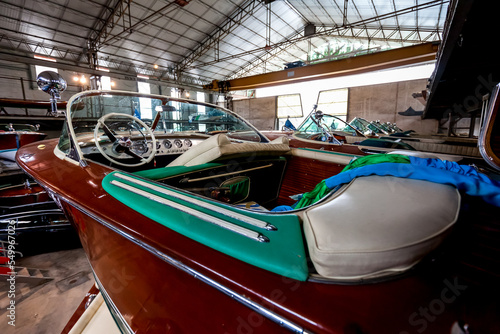 Classic wooden motor boats in shipyard