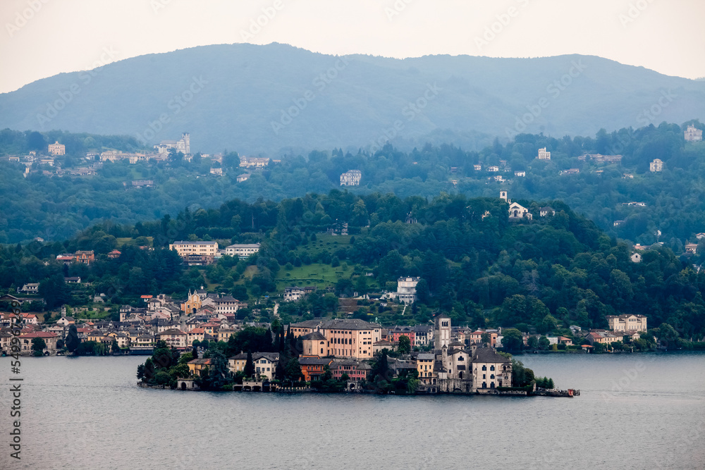 Mountain lake and city on green hills in Italy
