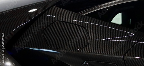 Sleek side view of carbon fiber sports car. Supercar background. Car wallpaper. Sleek sports car lambo. 