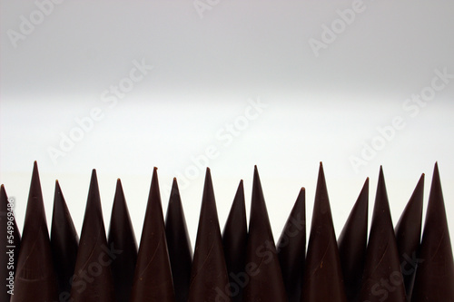 Elongated chocolates on white background