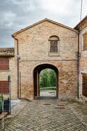 View of Monbaroccio, a little fortified village in the Province of Pesaro e Urbino in the Italian region Marche. One of the entrance of the city