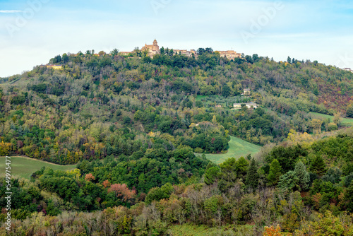 Autumn view of fields  and woods under Belvedere Fogliense  Region Marche of Italy. In the background appears the medieval city of Mondaino