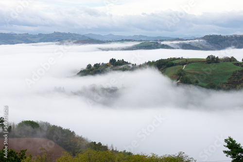 Morning mist and clouds over the Montefeltro hills near Belvedere Fogliense between Pesaro and Urbino in the Marche region of Italy