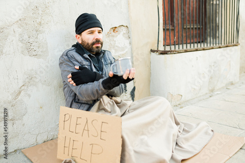 Tableau sur toile Cold homeless man shivering and begging for money