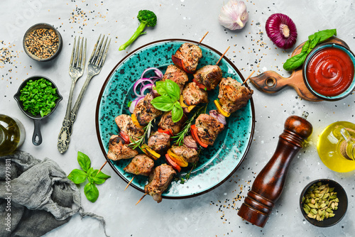 Fotografering Kebabs - grilled meat skewers, shish kebab with vegetables on a plate