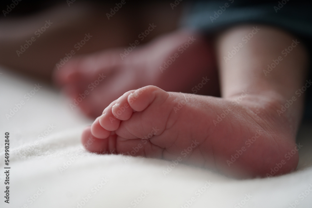 Newborn peel.Newborn Baby's foot with a blue blanket. Close up a baby's foot. Newborn peel.Newborn Baby's foot with a blue blanket. Close up a baby's foot.