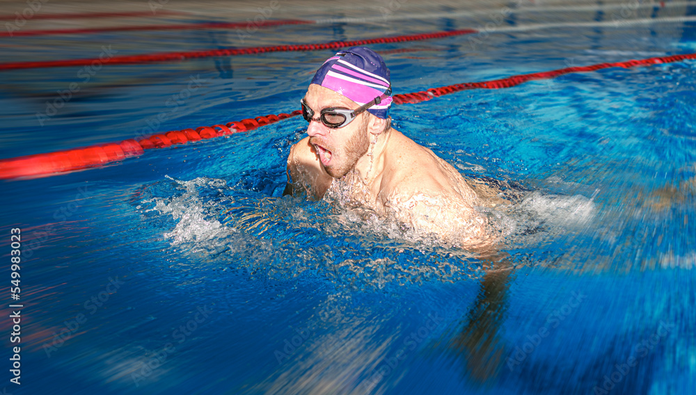 Swimmer in the pool. A male athlete is engaged in swimming in a sports pool.