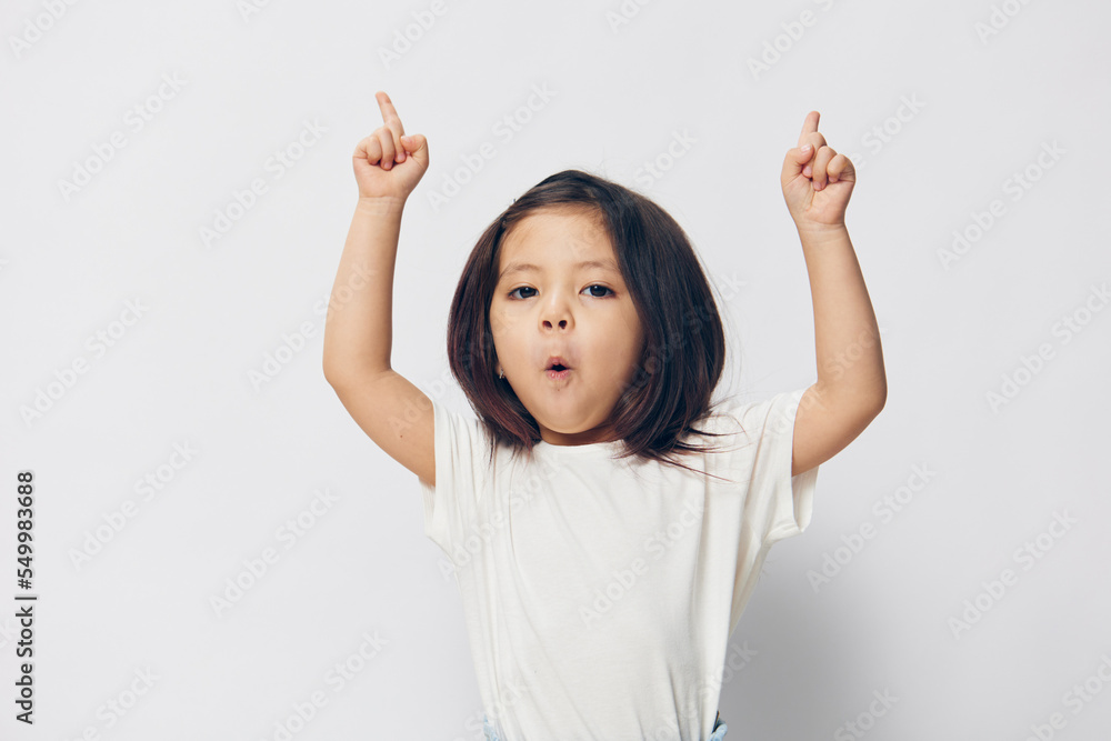 little joyful girl dancing on a light background little joyful girl dancing on a light background