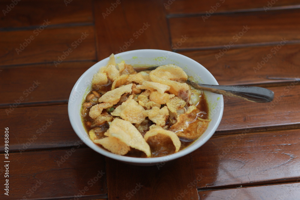 a close up of a ready-to-serve bowl of chicken porridge