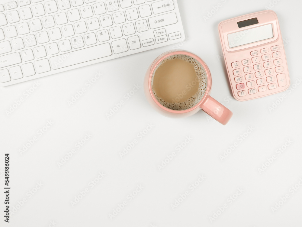 flat lay of computer keyboard, pink cup of coffee and pink calcularor on white background with copy space. flat lay of computer keyboard, pink cup of coffee and pink calcularor on white background with copy space.