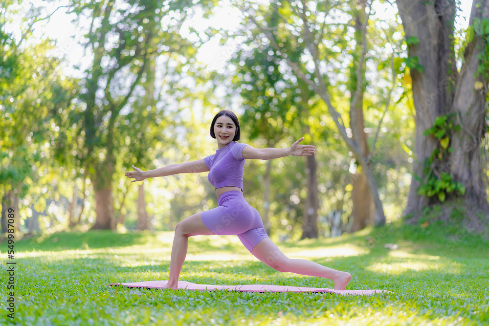 Fitness woman doing yoga in park, calm and relaxing women's happiness blurry background Asian woman meditating while practicing yoga concept of freedom peace and relaxation healthy Fitness woman doing yoga in park, calm and relaxing women's happiness blurry background Asian woman meditating while practicing yoga concept of freedom peace and relaxation healthy