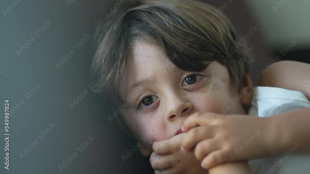 One concentrated child portrait face watching media cartoons off camera. Close up kid boy face One concentrated child portrait face watching media cartoons off camera. Close up kid boy face
