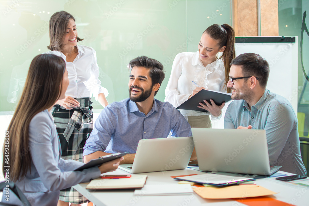 Group of friendly business people working together in the office.